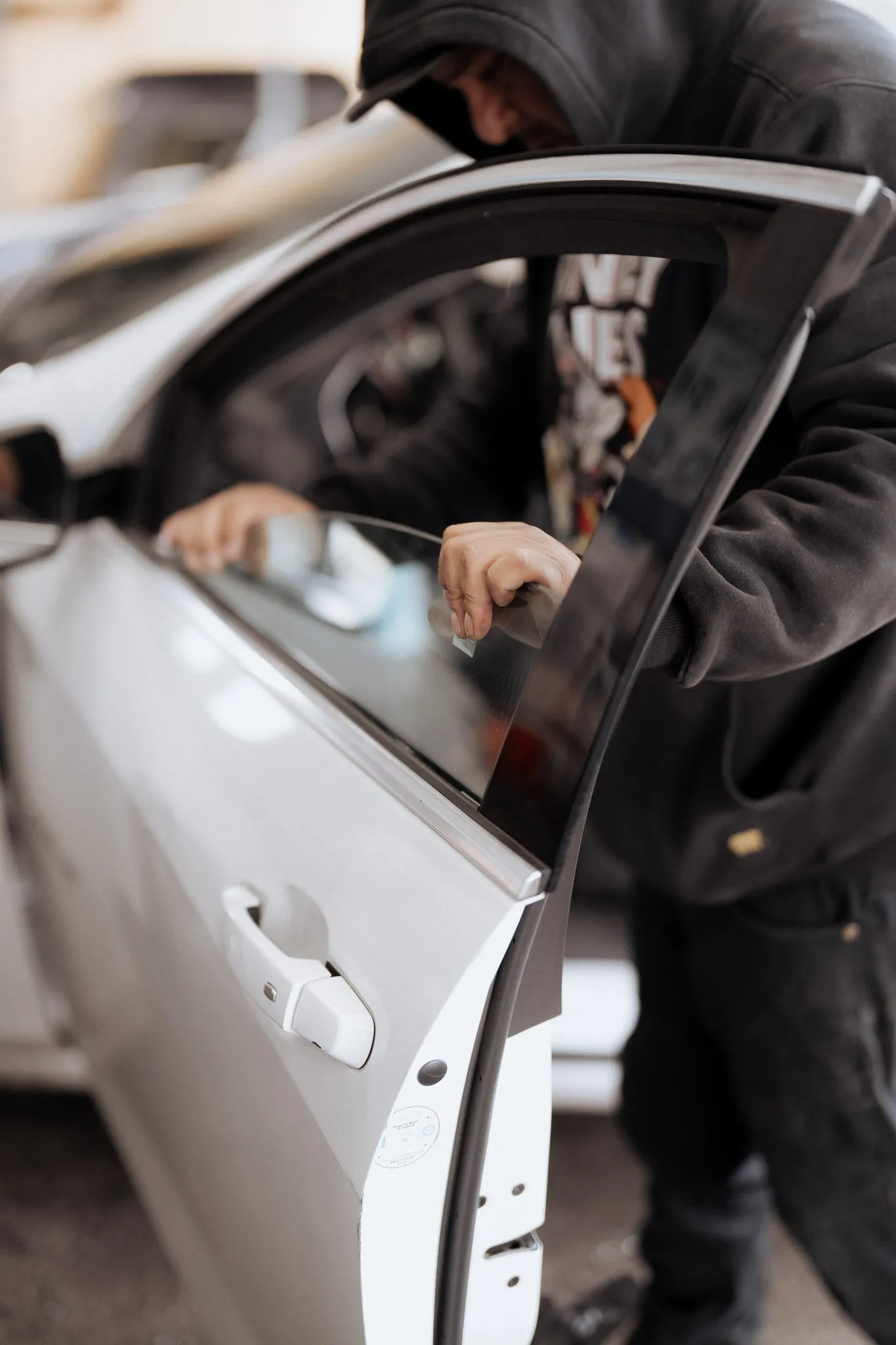 Professional windshield replacement — technician working on car window